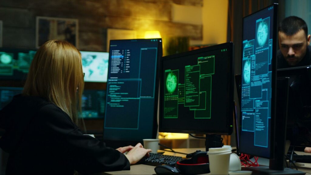 Image portraying a vigilant individual defending against cyber threats at a cybersecurity operations center.